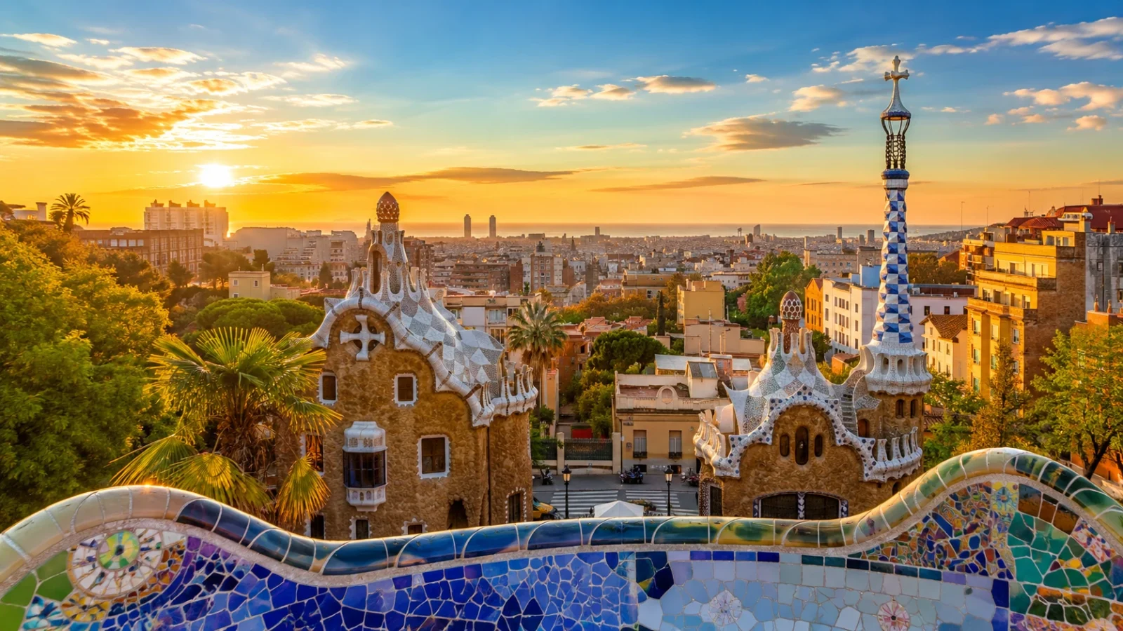 Park Güell in Barcelona overlooking the city and Mediterranean coast at sunset.