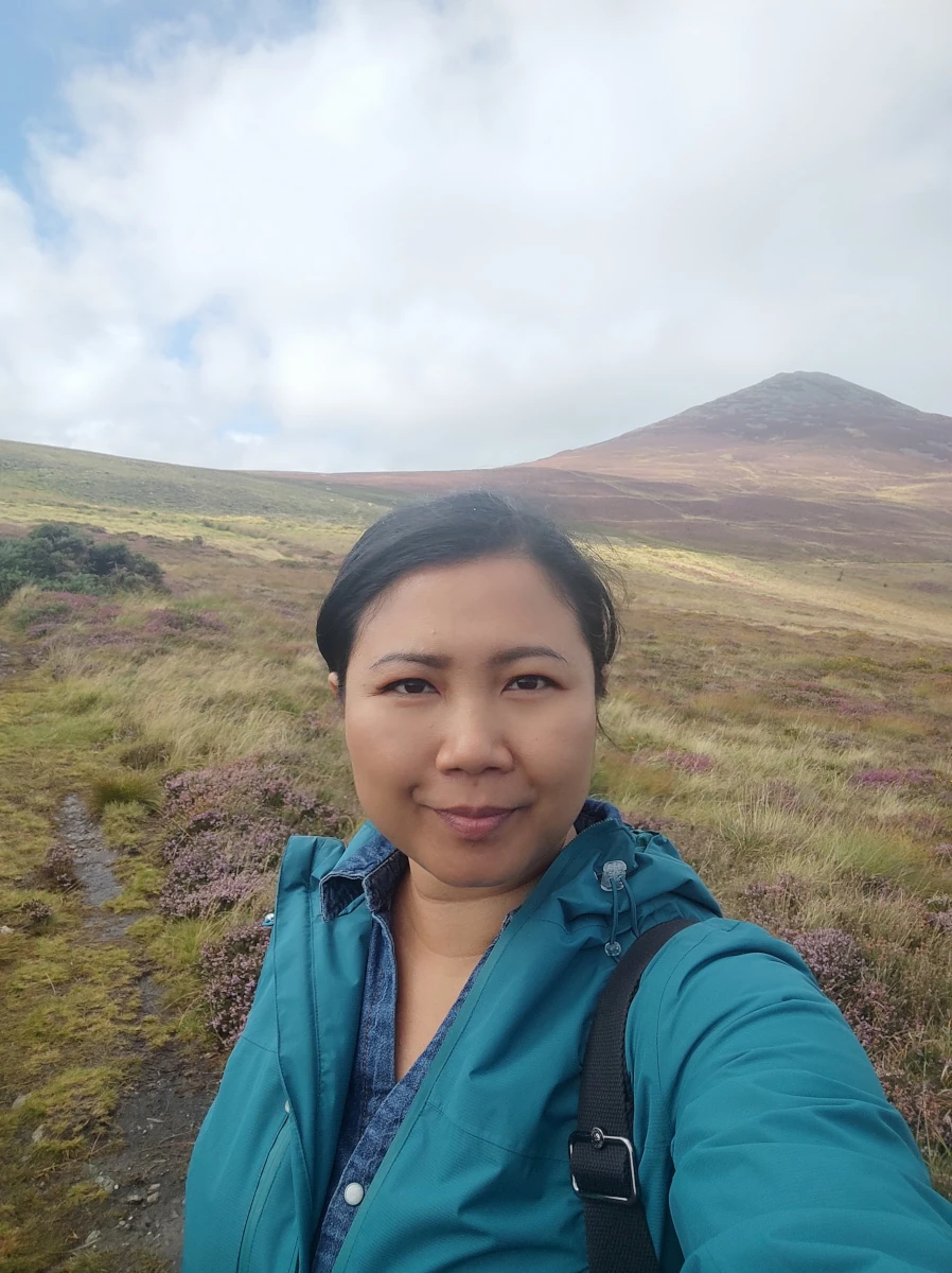 Hiker taking a selfie on the moorland trail with Yr Eifl rising in the background
