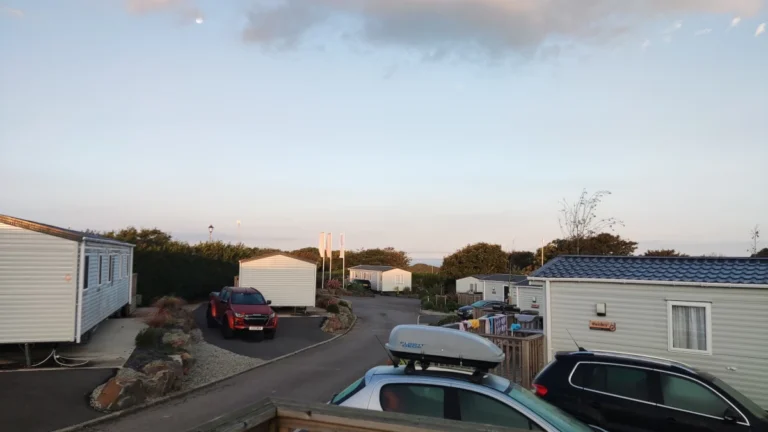 Row of static caravans in the Lighthouse Area at Twitchen House Holiday Park at dusk