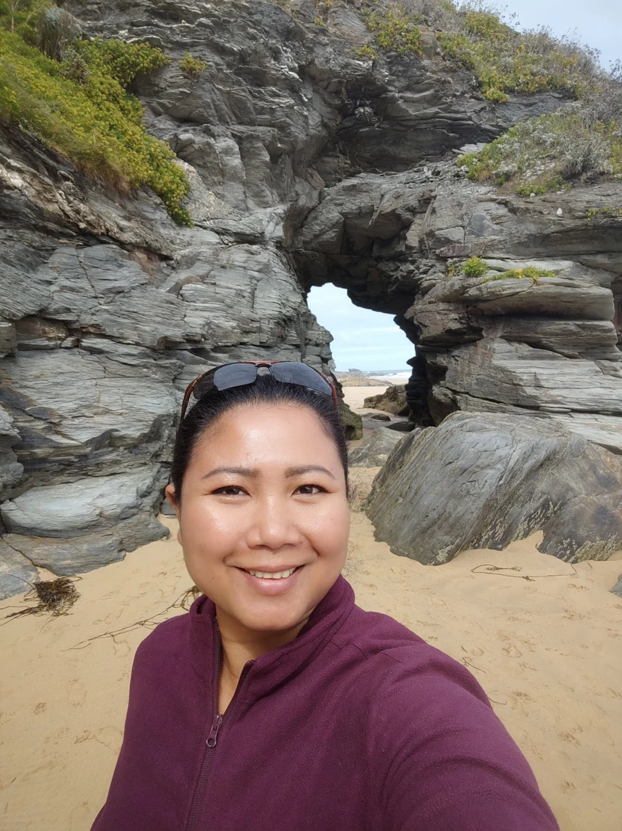 Selfie in front of a natural rock arch on the beach at Watergate Bay, Cornwall